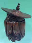 A oriental black rootwood carving of a scholar. Together with a lidded jar of sage form and a