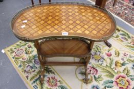 An early 20th Century French two tier small etagere with parquetry inlay and brass gallery.