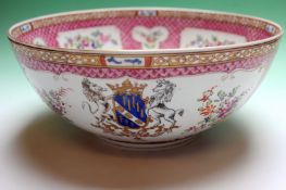 A Samson Chinese export armorial bowl with pink trellis borders. Painted with armorials. 30cm