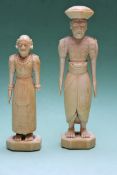 Two early 20th Century carved ivory figures of a man and a woman in ceremonial dress. 15 and 12cm