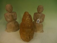 Two carved marble Oriental kneeling figures of deities. Together with a carved marble head of