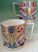 A pair of early 19th Century Derby porcelain tankards. With scrolled foliate designs and gilding.