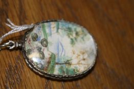 An early Continental oval hand painted reliquary depicting a Saint with child. The obverse with a