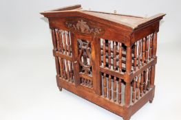 A 19th Century French food cabinet with spindle turned “cage” form lyre door and slatted shelves.