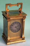 A late 19th Century French carriage clock with round silvered dial. Capital side columns. Double