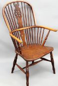 A 19th Century beech and elm Windsor armchair with shaped saddle seat.