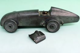 A circa 1930s pewter table lighter. Modelled in the form of a Magic M G Midget motor car. 19cm long.