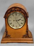 A 19th century oak cased bracket clock, arch top case with applied carved oak leaf decoration,