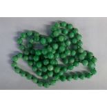 A single strand of jadeite beads. 57cm long.