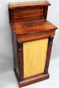 A William IV rosewood chiffonier/music cabinet. Brass gallery to raised back over a frieze drawer