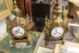 A near pair of late 19th Century gilt bronze desk clocks each with inset glass panels. Surmounted