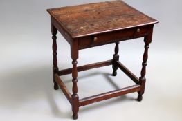 A 18th Century oak cottage side table. Moulded edge top over frieze drawer on turned legs united