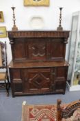 An 18th Century and later oak court cupboard. Carved frieze over shallow cupboard single door and