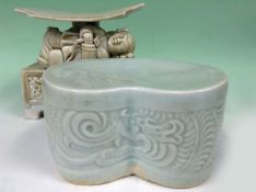 Two Chinese headrests/pillows. One Qinbai the other of a celadon glaze. (2)