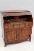 A Regency mahogany tambour fall front bureau cabinet with pull out leather inset writing slide.
