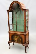 A George II style walnut display cabinet. Panel glass door and glass shelves over paint decorated