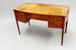 An Edwardian Regency style inlaid satinwood bowfront writing table with leather inset top over