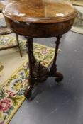 An inlaid burl walnut Victorian circular work table. Fitted fretwork interior. Fluted tripod