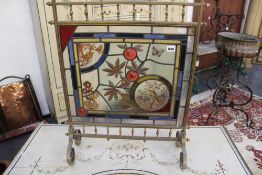 A Victorian aesthetic brass and stained glass fire screen. Inset panel of birds and insects.