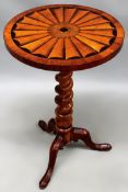 A carved and inlaid Victorian cedarwood lamp table. Circular top with radiating fan inlay. Spiral