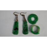 A pair of Chinese pierced jadeite drop earrings together with a ring and a circular boss. (4)