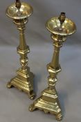 A pair of antique Flemish brass pricket candlesticks adapted as lamps. Baluster shafts on triangular