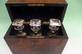 A mid 19th Century burl walnut decanter box. Lift top opens to reveal three cut glass decanters