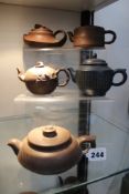Five assorted terracotta teapots.
