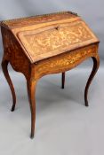 An antique French marquetry inlaid Louis XV style ladies desk with brass gallery. Slant top encloses