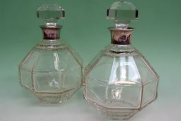 A pair of silver mounted octagonal glass decanters. Birmingham 1929. Retailer Asprey and Co. 22cm