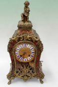 A French Boulle mantel clock with gilt mounts and enamelled numerals. Glass front and side panels,