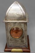 An Arts & crafts pewter mantel clock. With drum head movement. Hammered decoration. Bears
