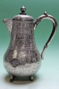 A late 19th Century silver coloured metal coffee pot decorated with figure on horseback. Possibly of