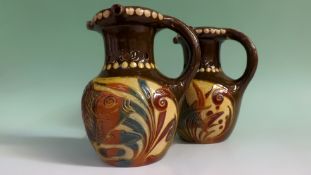 A pair of Lauder Barum pottery puzzle jugs incised with fish designs in the Arts and Crafts