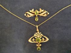 An Art Nouveau 15ct peridot and seed pearl openwork brooch cum pendant together with a similar