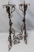 A pair of antique wrought iron Baroque style pricket floor standing candlesticks. Scroll work shafts