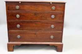 A George III mahogany and crossbanded bachelor’s chest. Moulded edge top over brushing slide and