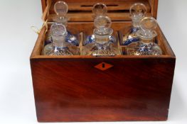 A 19th Century mahogany decanter box fitted with six glass decanters decorated with gilding. 29cm