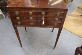 A Georgian mahogany dressing table. Twin fold open cover revealing a fitted interior over four