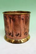 A WMF copper and brass bottle coaster. 9cm high. 10cm diameter. An Arts and Crafts pewter casket, 19