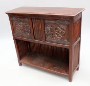 A 19th Century Continental oak livery cupboard with carved doors and hard wrought hinged and