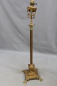 A late Victorian brass Corinthian column drawing room oil lamp. Plinth base rests on four paw