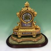 A Victorian mantel clock, fine cast gilt brass case inset with hand painted porcelain panels and