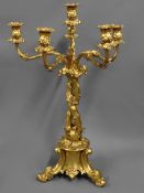 A 19th Century gilded five branch table candelabra embellished with vine decoration on three deep