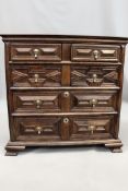 A Cromwellian and later oak chest of drawers with moulded panelled front, fitted with two short