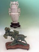 A Chinese green jadeite model of two rams cavorting with plinth. 14cm long (boxed).