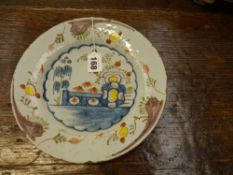 An antique delft dish. With polychrome decoration. Possibly Bristol. 23.5cm diameter.