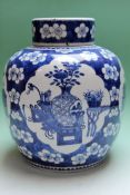A Chinese blue and white ginger jar with cover decorated with symbolic objects. 27cm high.