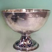 An Arts and Crafts silver and enamel pedestal cup with blue, red and green enamelled base and