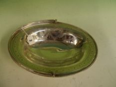 A large oval silver cake basket with swing handle by Barnard and Sons, London 1874, with central